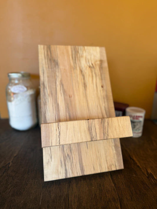 Wooden cookbook stand on a wooden surface